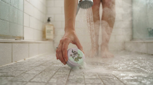 Warm shower water and steam rising around a botanical bath product