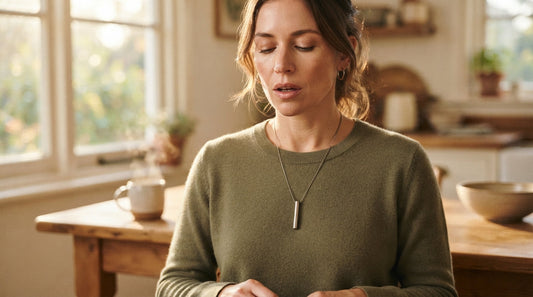 A woman wearing a breathing necklace pendant