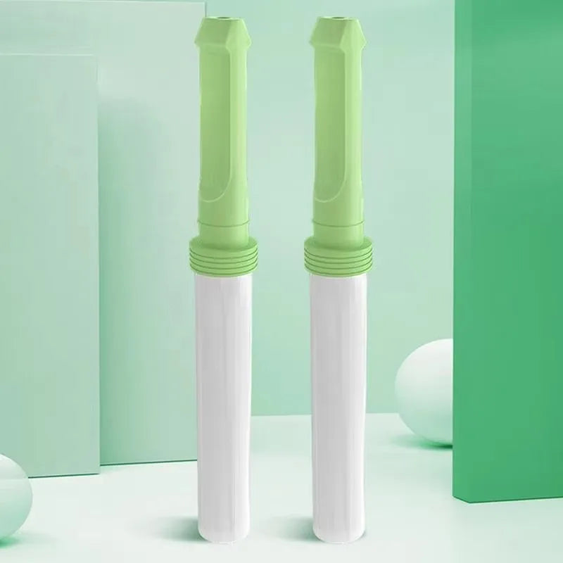 A pair of green-topped nicotine-free air inhalers standing upright on a soft green studio background