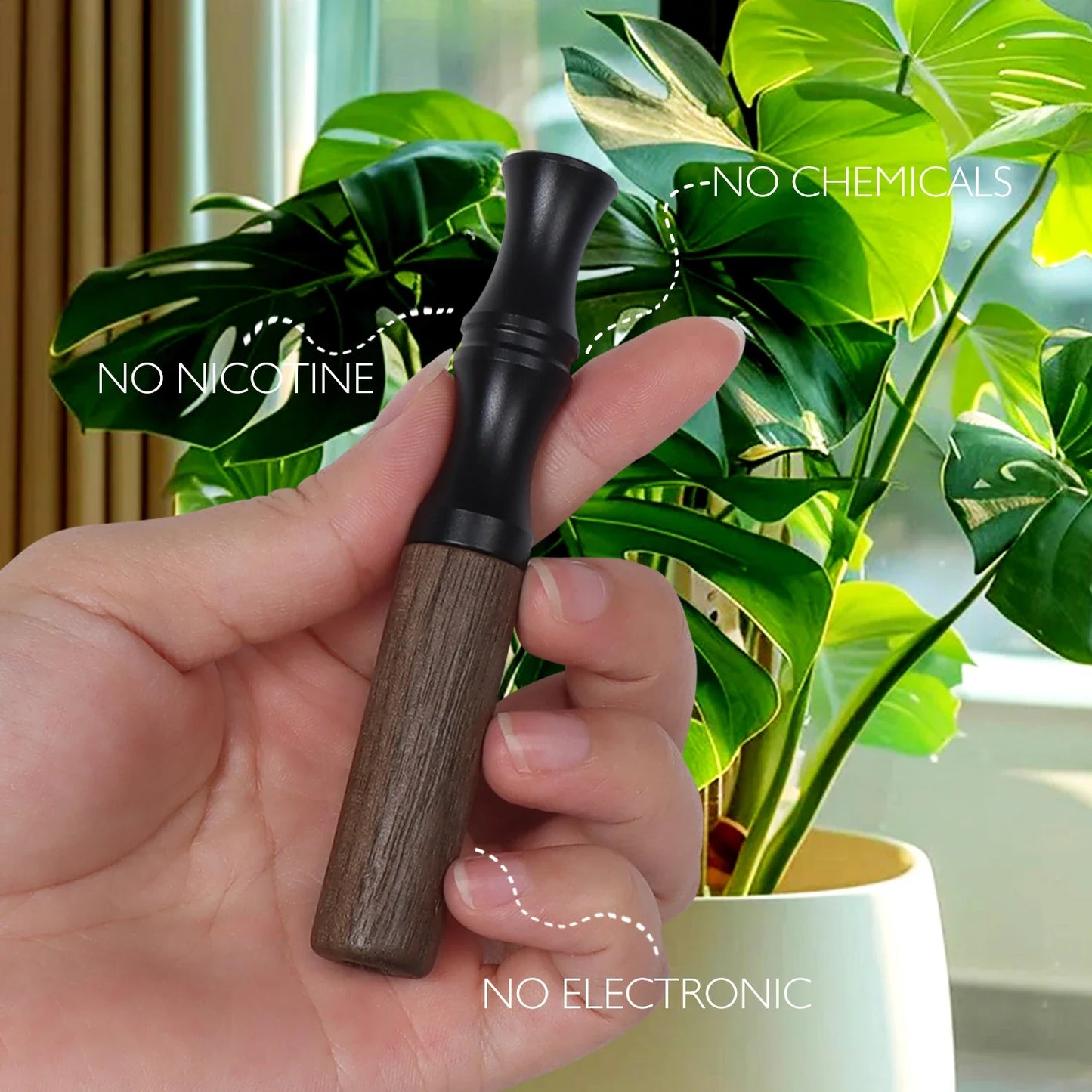 Wooden inhaler stick with black mouthpiece and walnut-toned lower body held beside a green houseplant, smokeless and nicotine-free